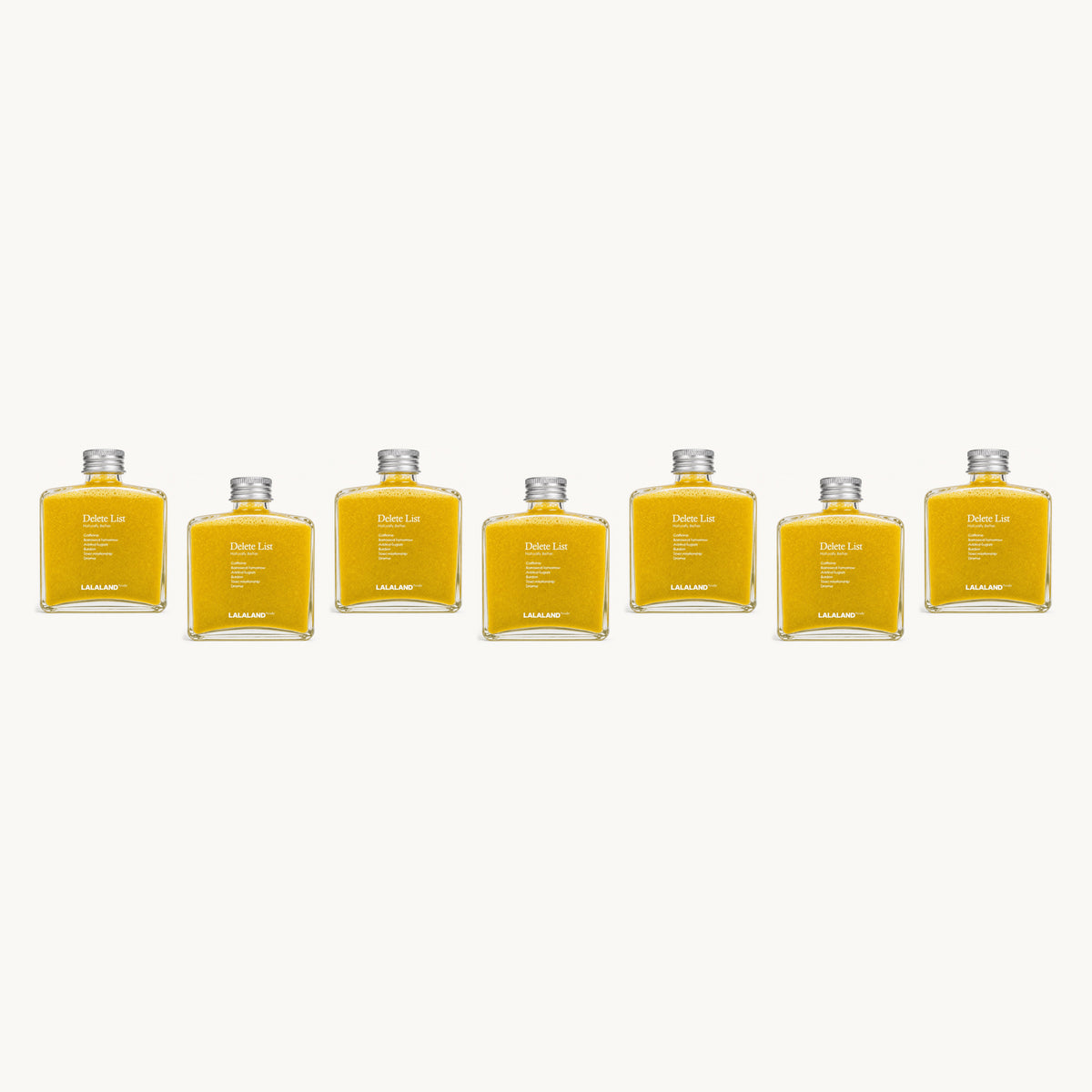 Lalaland® turmeric-team — 7 bottles, single staggered row: yellow, yellow, yellow, yellow, yellow, yellow, yellow